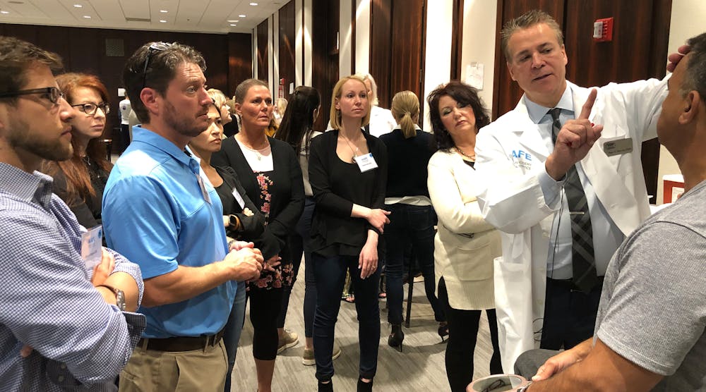 AAFE faculty member Dr. Peter Harnois teaches Botox to attendees at the ADA headquarters.