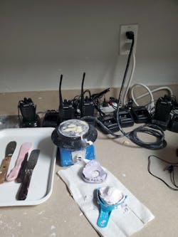 Interoffice communications devices, which are held proximal to workers’ ears and mouths, are recharged and stored adjacent to dental biohazards. Interoffice communications devices, which are held proximal to workers’ ears and mouths, are recharged and stored adjacent to dental biohazards.