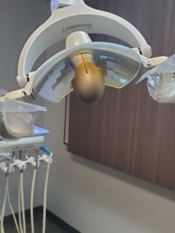 A protective shield is missing from the dental operatory light fixture. The fixture is clearly and appropriately labeled “Hot surfaces on light head. Use handles for adjustment.” A blowout of this high intensity medical-grade lamp bulb risks potential serious injury to personnel and patients. Further, lacking a protective light shield, necessary surface area infection control cannot be accomplished to mitigate potential biohazards of blood and saliva splatter. A protective shield is missing from the dental operatory light fixture. The fixture is clearly and appropriately labeled “Hot surfaces on light head. Use handles for adjustment.” A blowout of this high intensity medical-grade lamp bulb risks potential serious injury to personnel and patients. Further, lacking a protective light shield, necessary surface area infection control cannot be accomplished to mitigate potential biohazards of blood and saliva splatter.