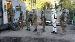 A queue of soldiers (one even sporting a Star Wars costume) for mobile dental clinic Tryzub Dental.