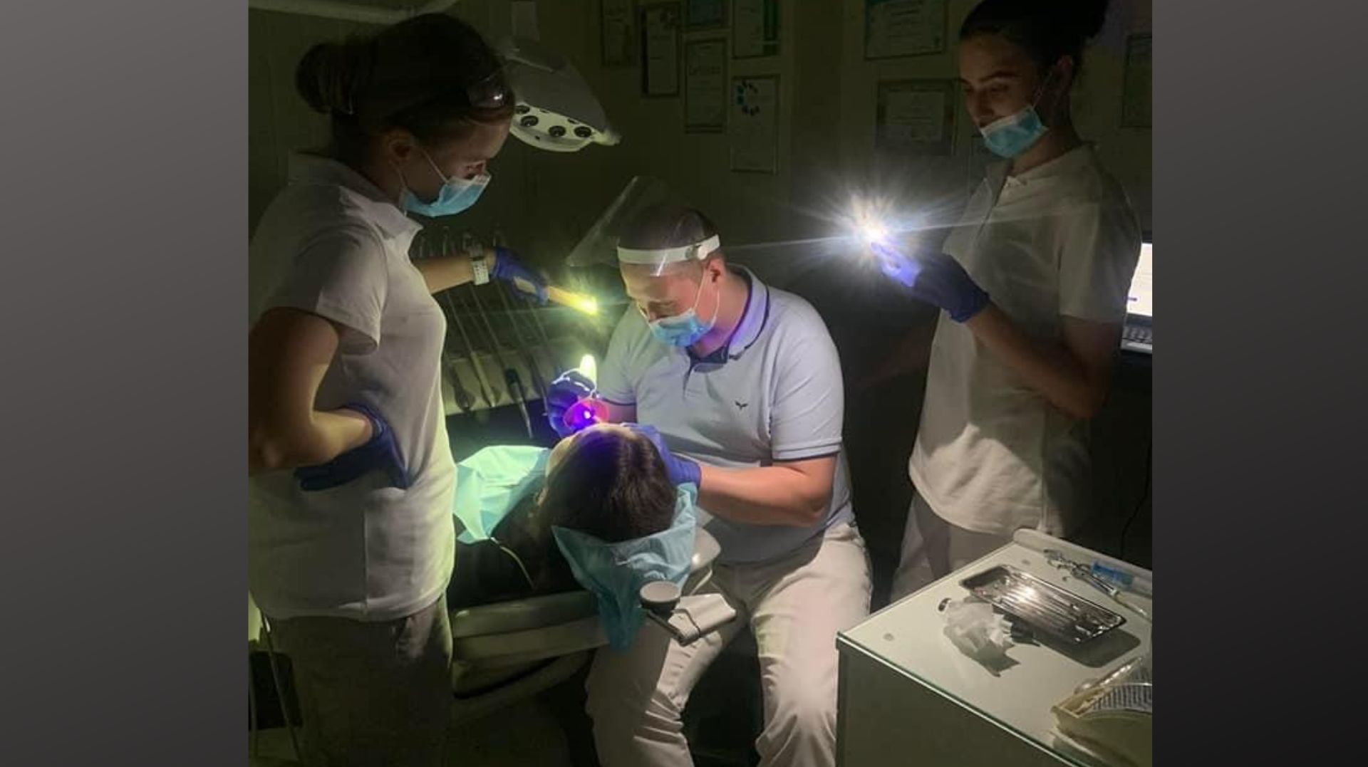 Dr. Andriy Biliak and his assistants perform dental treatment during a blackout.