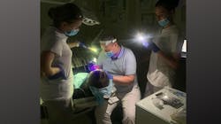 Dr. Andriy Biliak and his assistants perform dental treatment during a blackout. Dr. Andriy Biliak and his assistants perform dental treatment during a blackout.