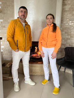 Dr. Serhii Bas and his assistant stand near the fireplace at his dental office, Profident Dreamhouse In Odesa. Dr. Serhii Bas and his assistant stand near the fireplace at his dental office, Profident Dreamhouse In Odesa.