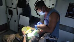 Dr. Drobotenko in his mobile dental clinic treating a military patient. Dr. Drobotenko in his mobile dental clinic treating a military patient.