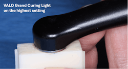 Figure 4: The light beam coming from a curing light must be perpendicular to the resin surface for adequate cure, as shown on this resin sample in the mold.