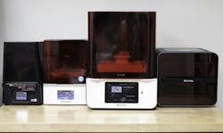 Figure 4: An array of 3D printers designed for dental offices, demonstrating their capability to produce high-quality dental restorations on-site Figure 4: An array of 3D printers designed for dental offices, demonstrating their capability to produce high-quality dental restorations on-site