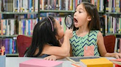 Two girls checking their teeth Two girls checking their teeth