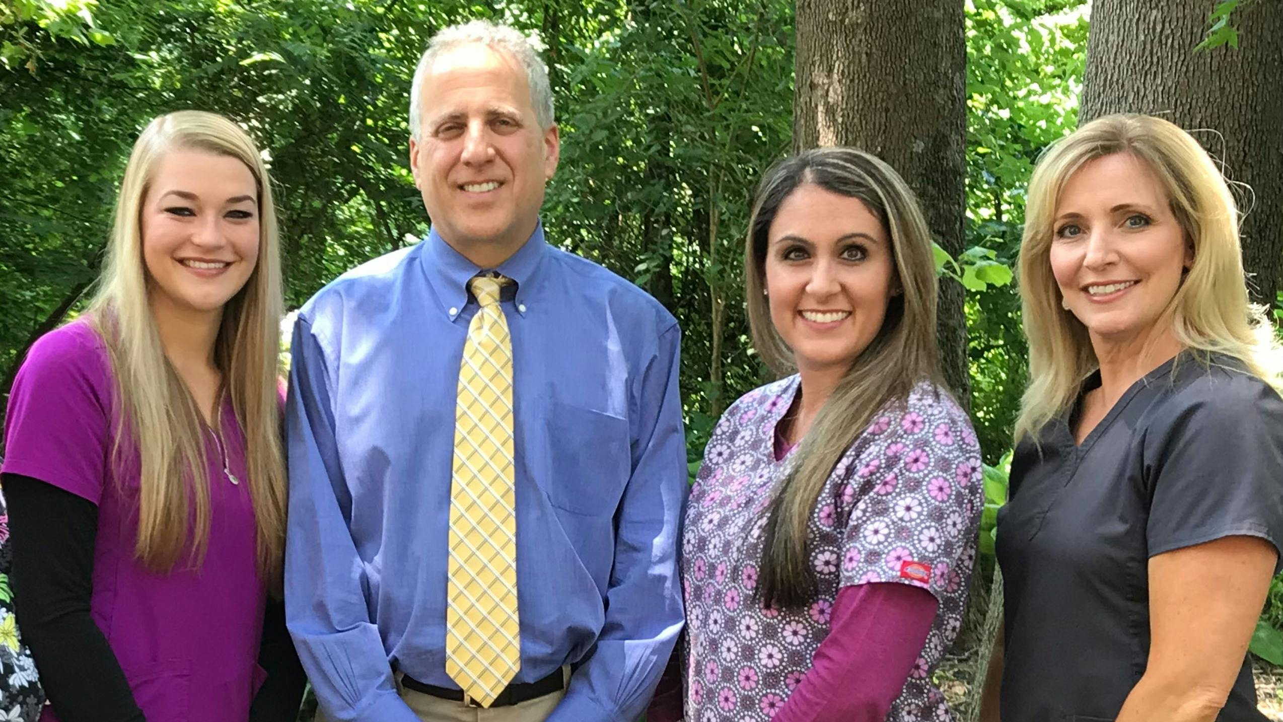 Dr. Robert Minch with his small staff, from left: Kyleigh, dental assistant; Dr Minch; Corinne, dental hygienist; and Tina, front desk manager.