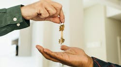 person handing over keys person handing over keys