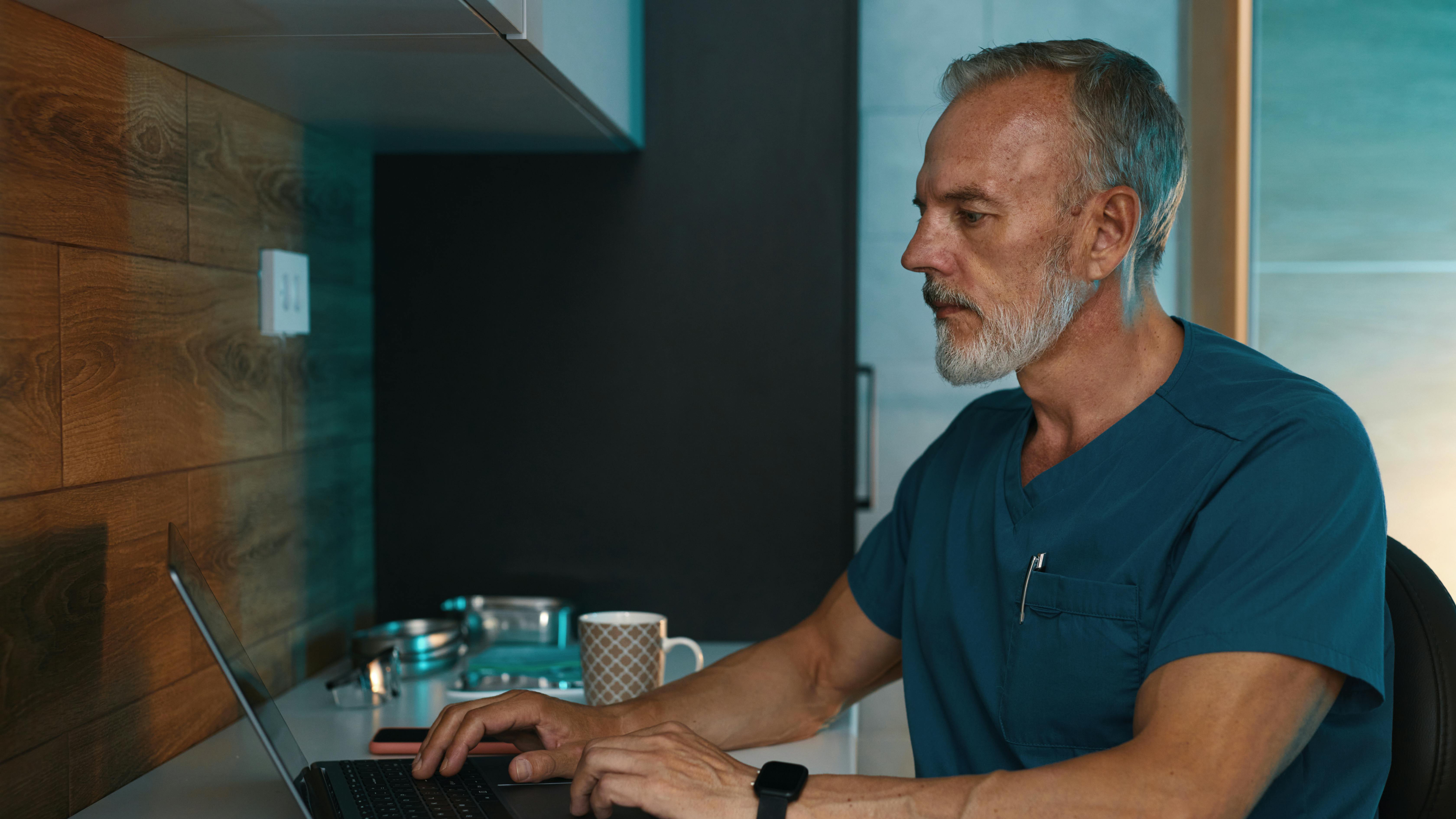 Dentist sitting at computer