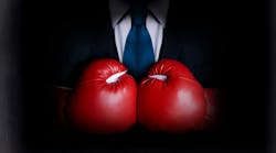 Business man wearing boxing gloves Business man wearing boxing gloves