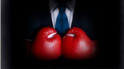 Business man wearing boxing gloves Business man wearing boxing gloves