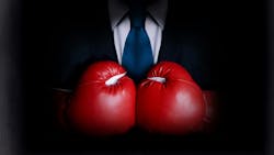 Business man wearing boxing gloves Business man wearing boxing gloves