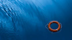 A lifebuoy ring on a blue water background A lifebuoy ring on a blue water background
