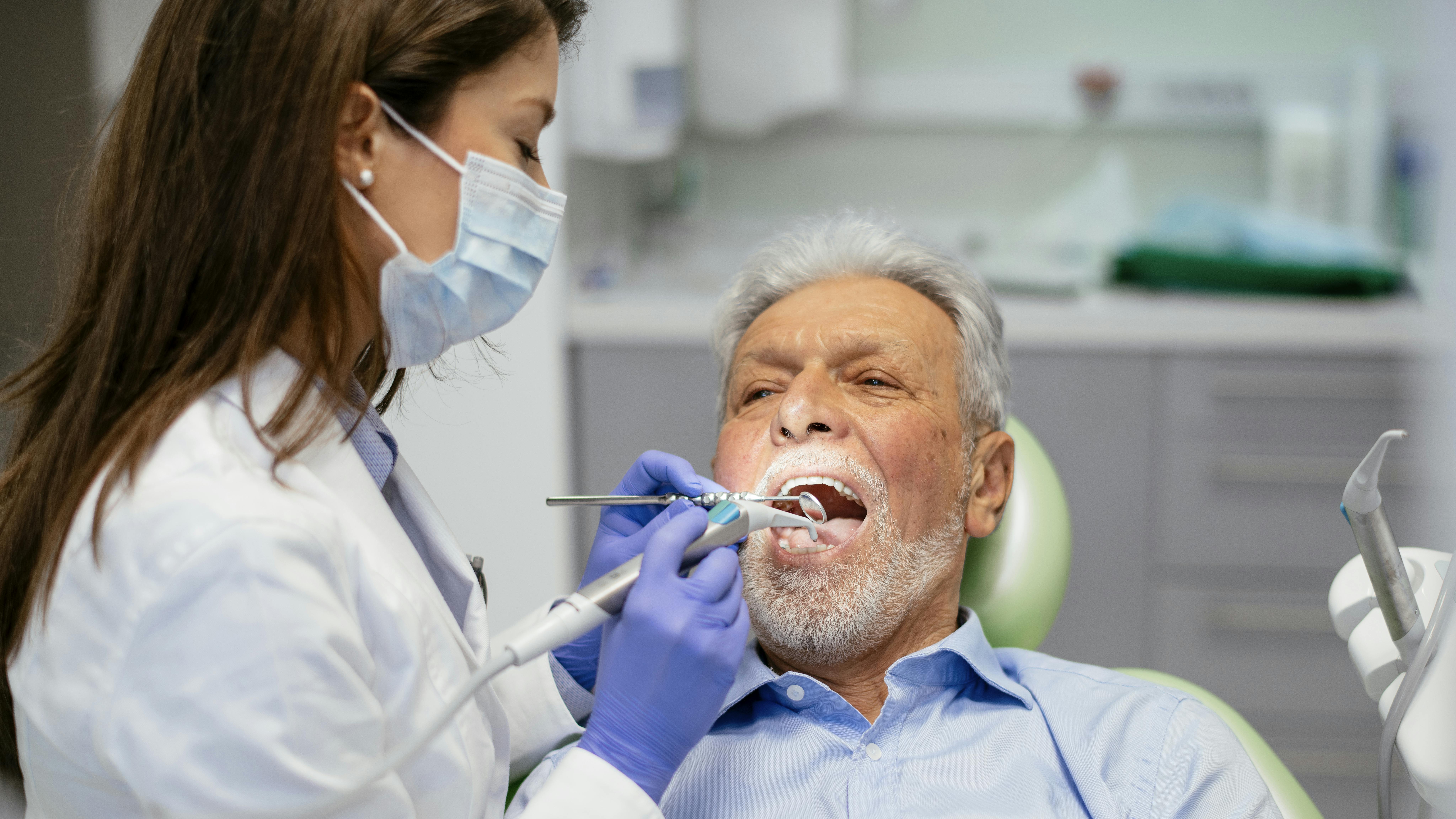 Dentist providing periodontal treatment