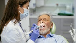 Dentist providing periodontal treatment Dentist providing periodontal treatment