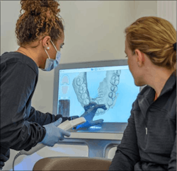 Dental pro and patient looking at intraoral scan Dental pro and patient looking at intraoral scan