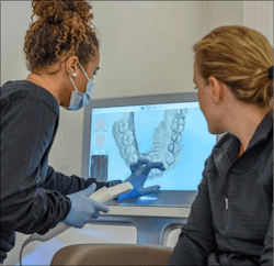 Dental pro and patient looking at intraoral scan Dental pro and patient looking at intraoral scan