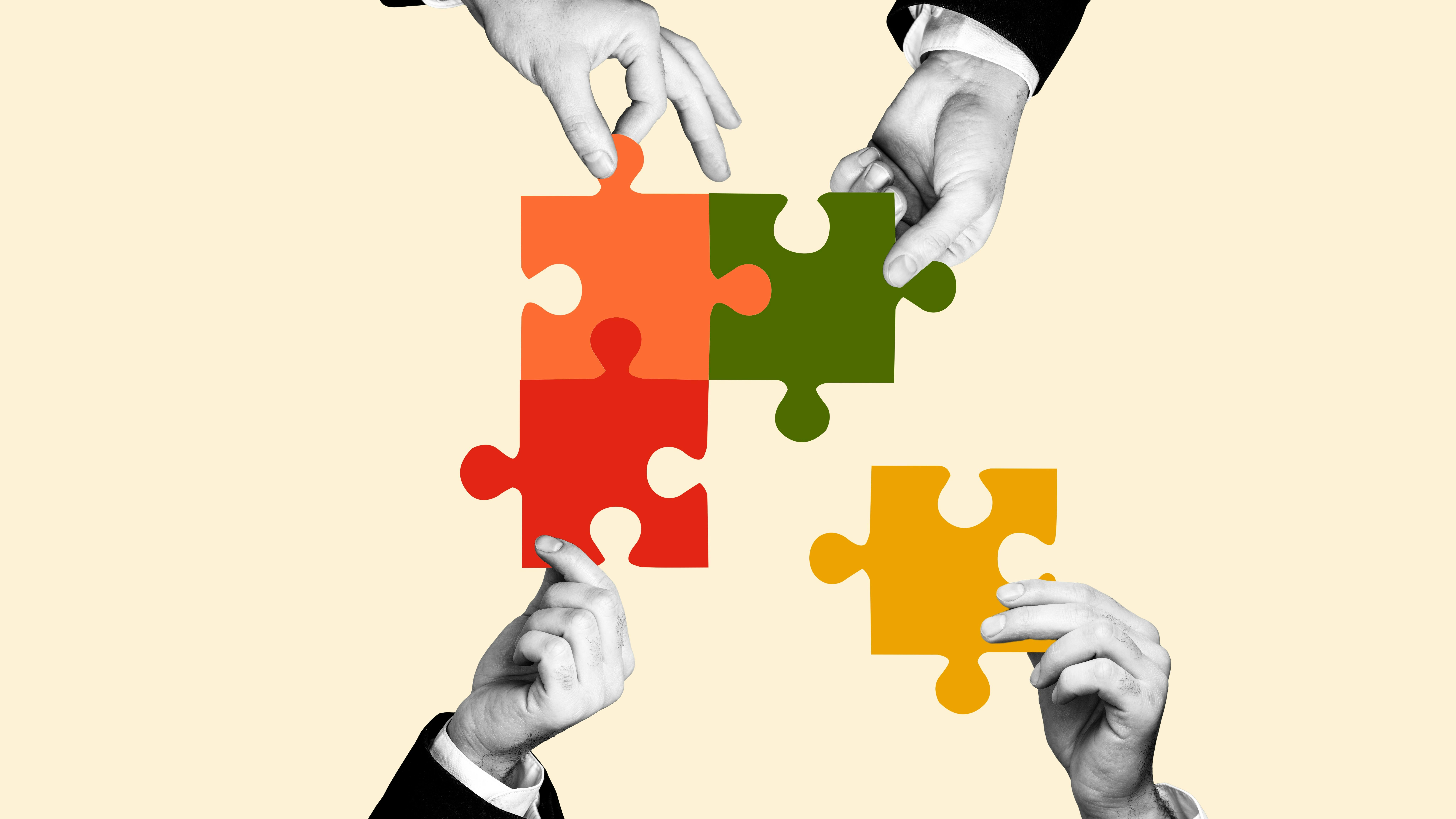 Hands holding puzzle pieces