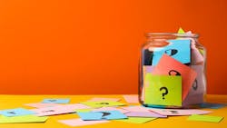 a jar filled with colorful notes that have question marks on them a jar filled with colorful notes that have question marks on them
