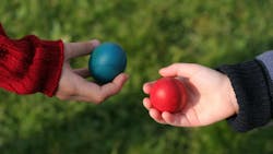 Two outstretched hands, each holding a ball, as if in trade Two outstretched hands, each holding a ball, as if in trade