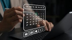 Person holds stylus and interacts with digital calendar Person holds stylus and interacts with digital calendar