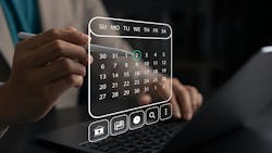 Person holds stylus and interacts with digital calendar Person holds stylus and interacts with digital calendar