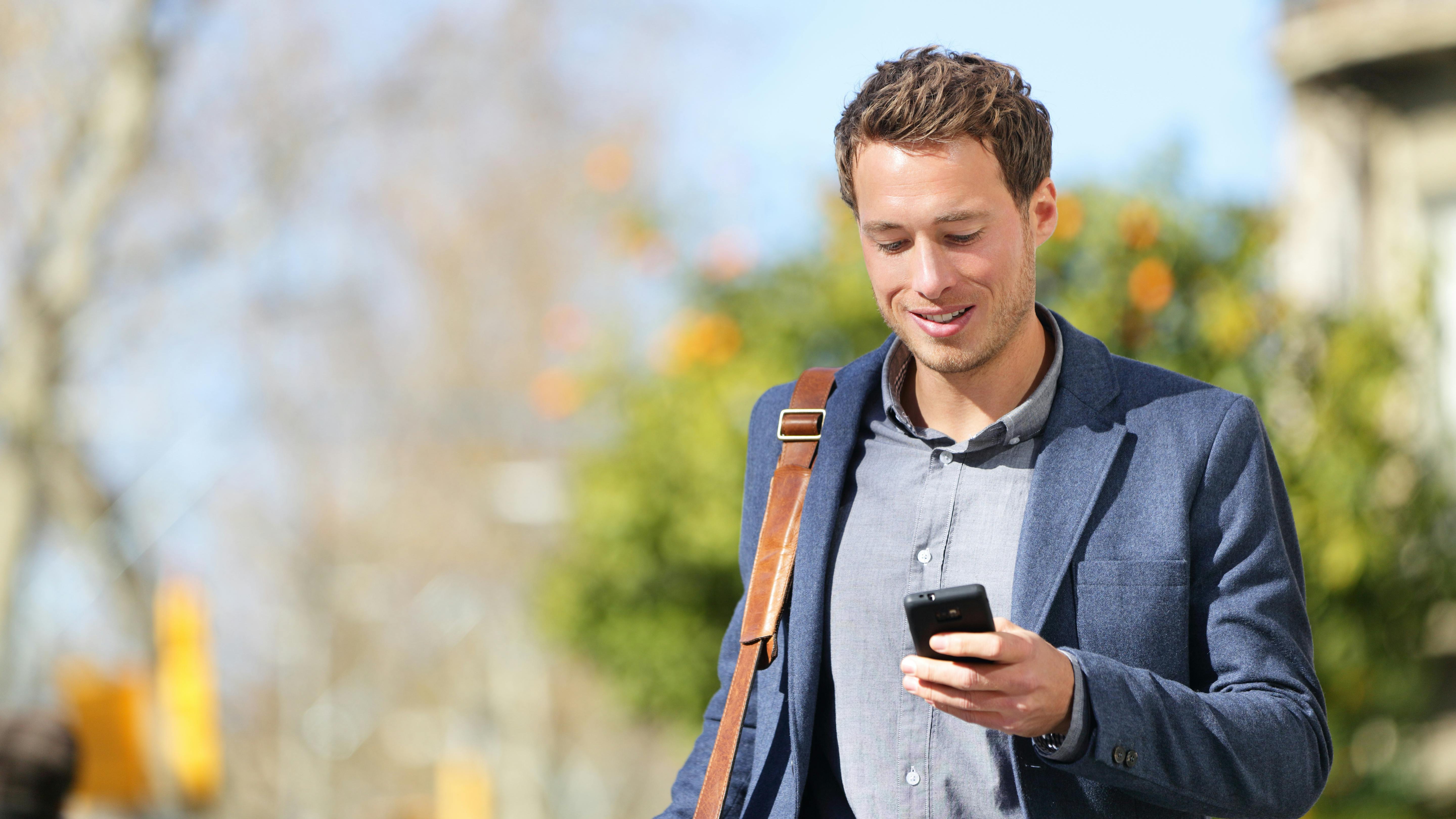 Young professional man with bag and smartphone