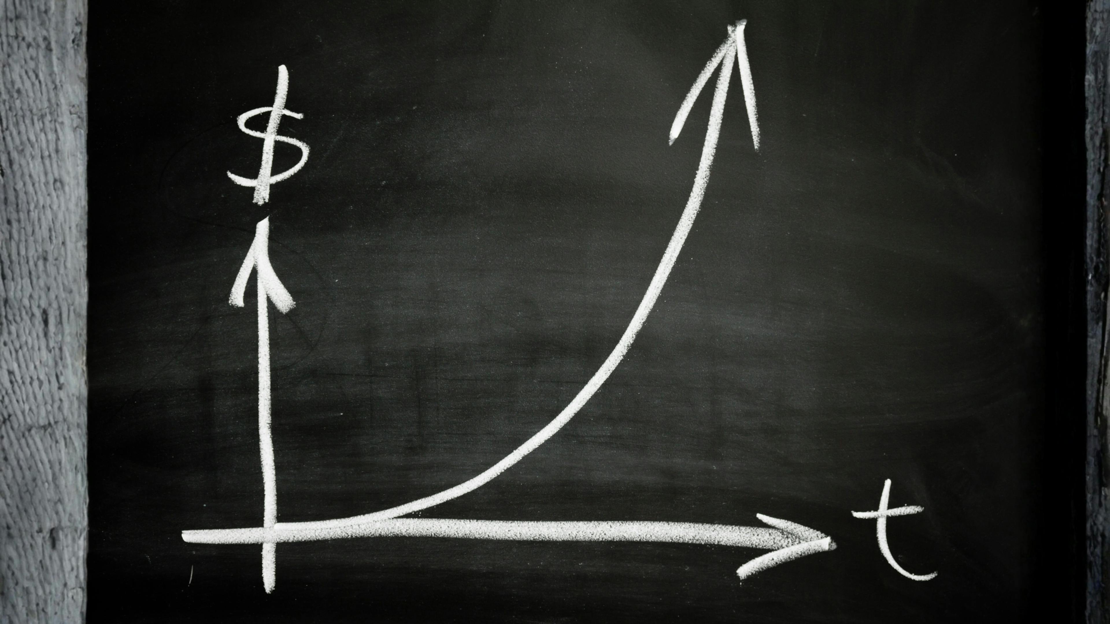 Chalkboard with simple line graph showing money going up over time