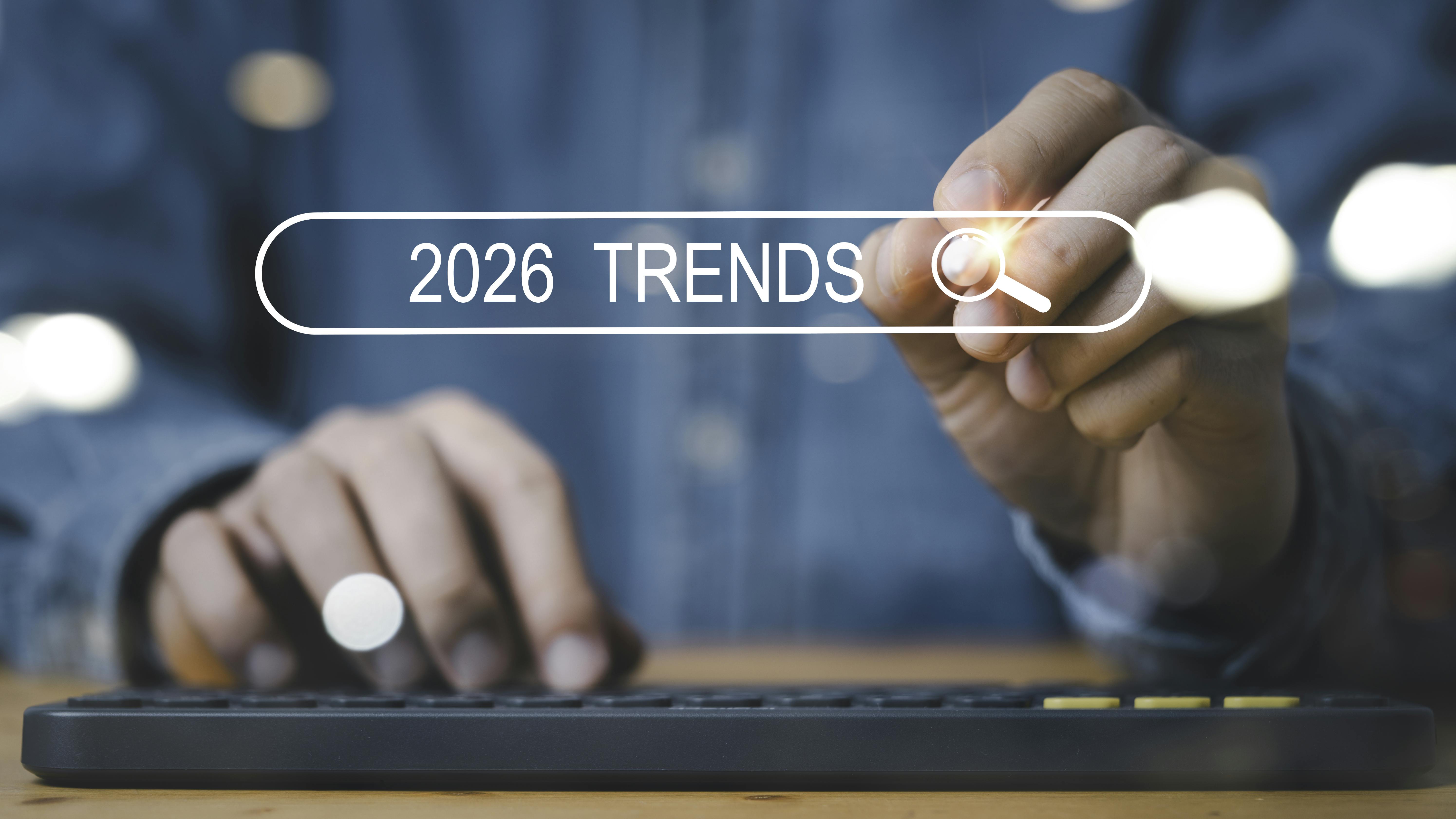 Person holding iPad pencil with '2026 Trends' overlaid text
