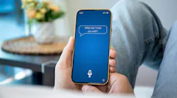 Person holding iPhone with 'What can I help you with' text on screen Person holding iPhone with 'What can I help you with' text on screen