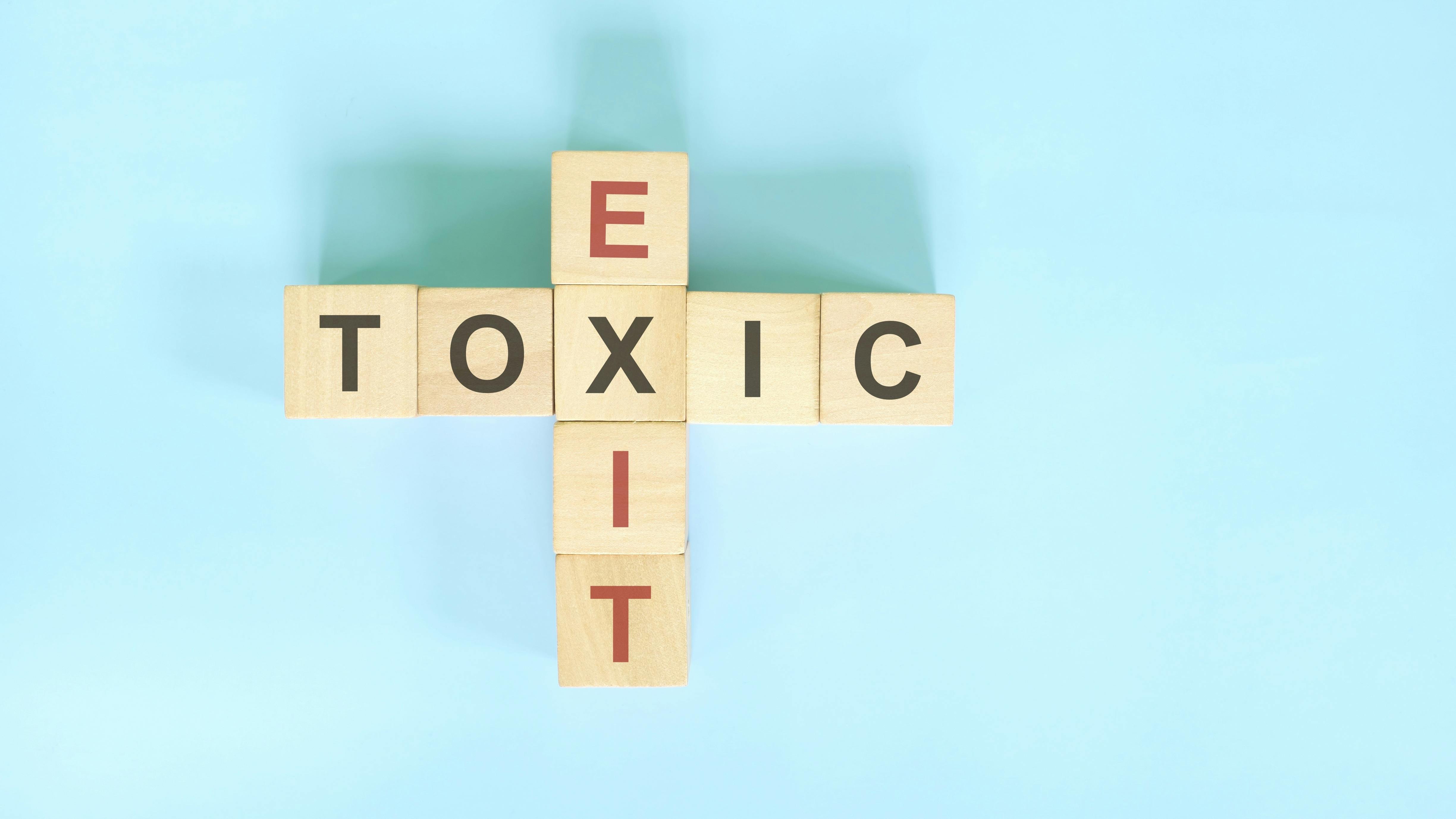 Scrabble tiles reading 'TOXIC' and 'EXIT'