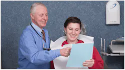 a dentist talking to a dental patient a dentist talking to a dental patient