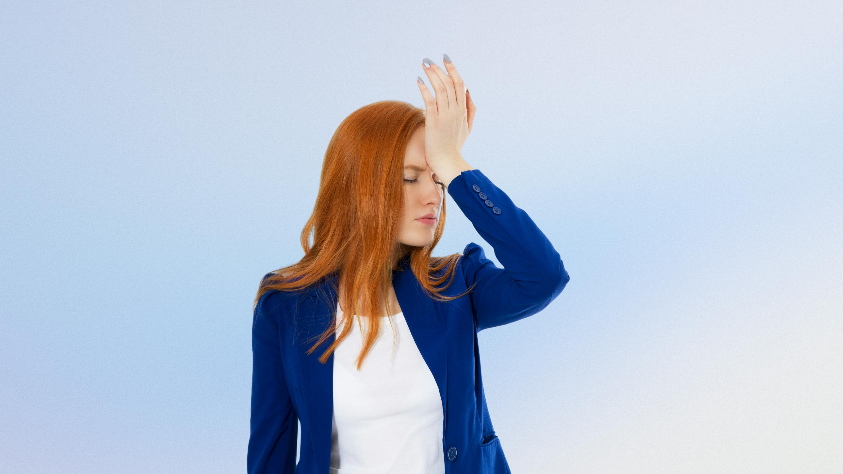 Woman with palm to forehead