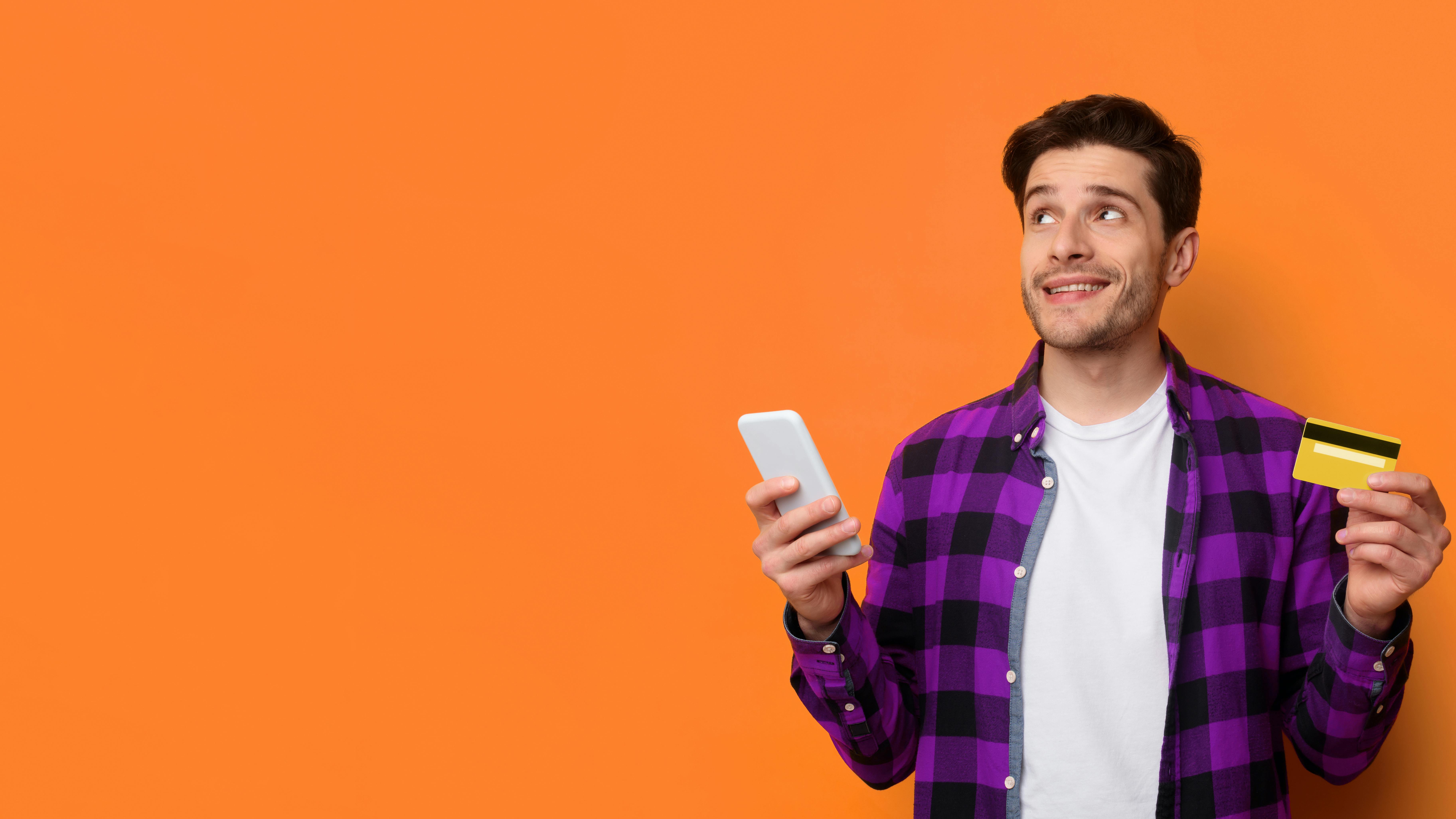 Man holding phone and credit card