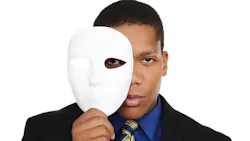 man holding up a mask to his face man holding up a mask to his face