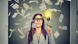 Paper money falls in the foreground as woman holds up a finger near a lightbulb