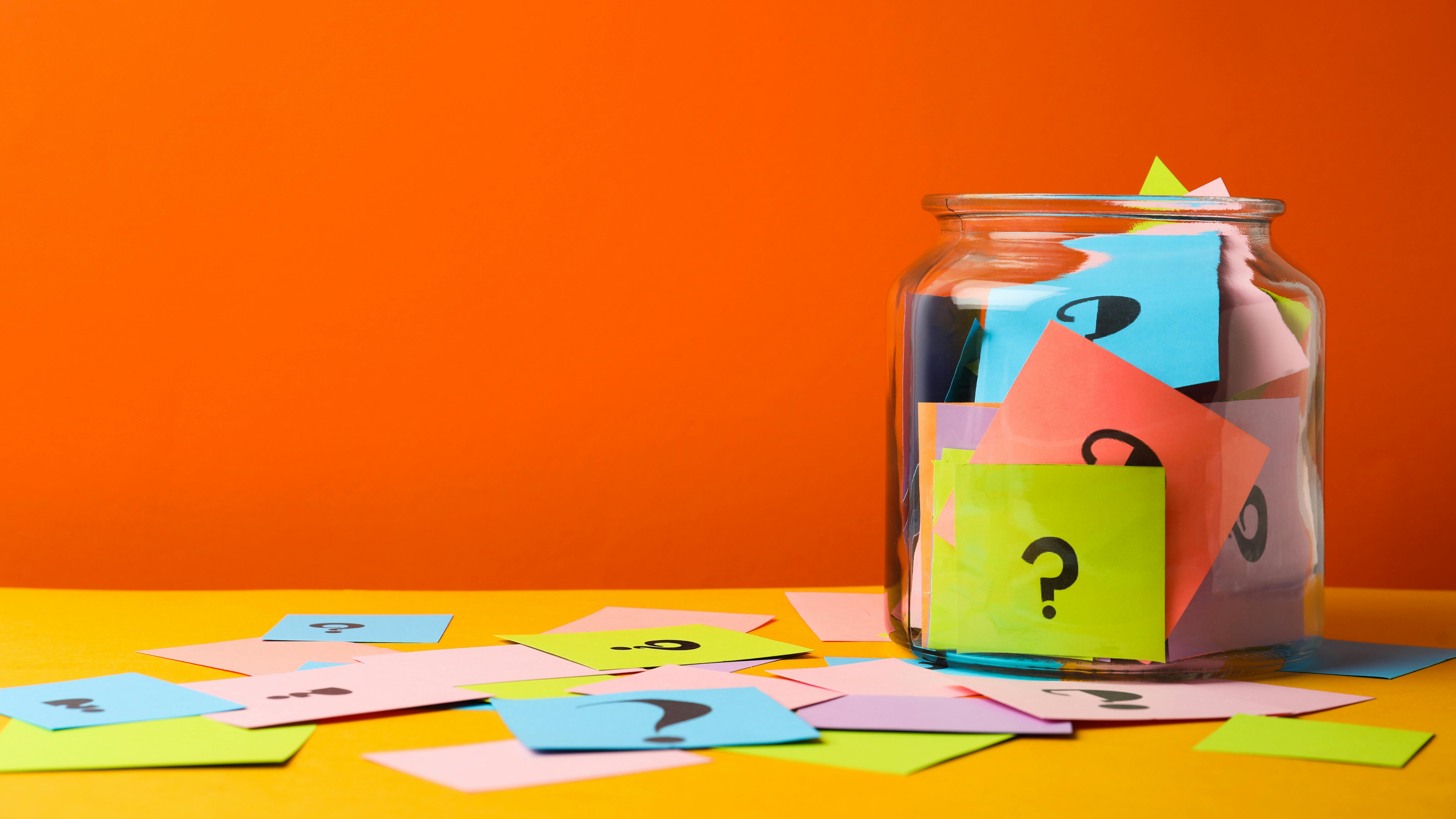 a jar with colorful notes with question marks on them
