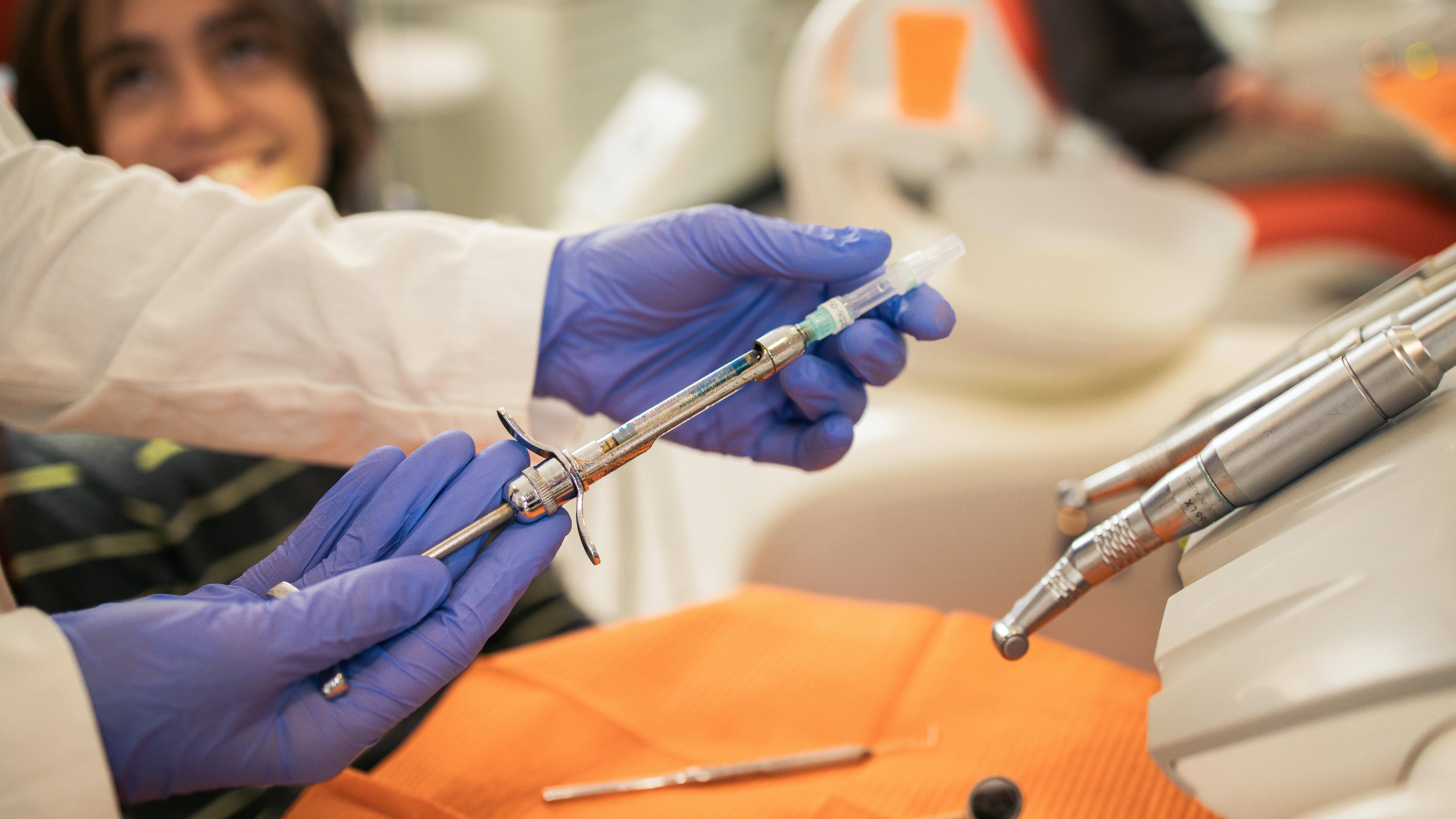dentist preparing a local anesthetic for a dental patient